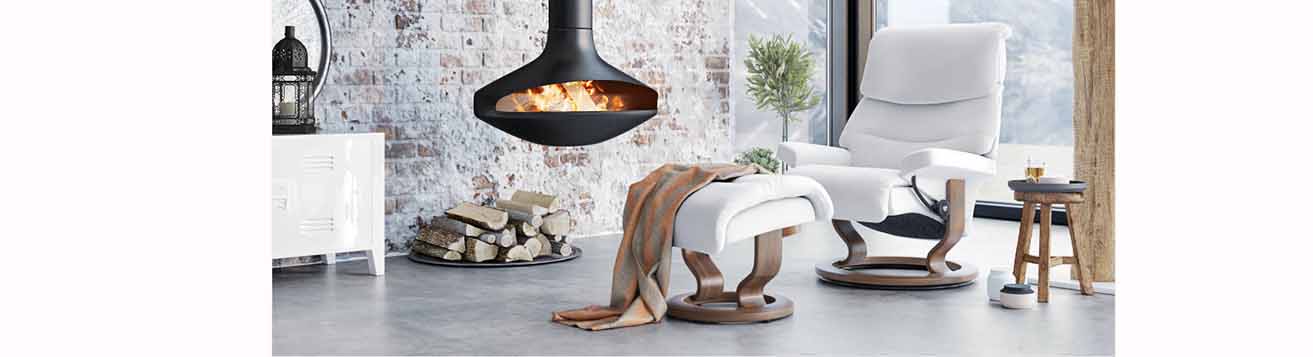Capri recliner classic base in modern room setting with wood burning fireplace